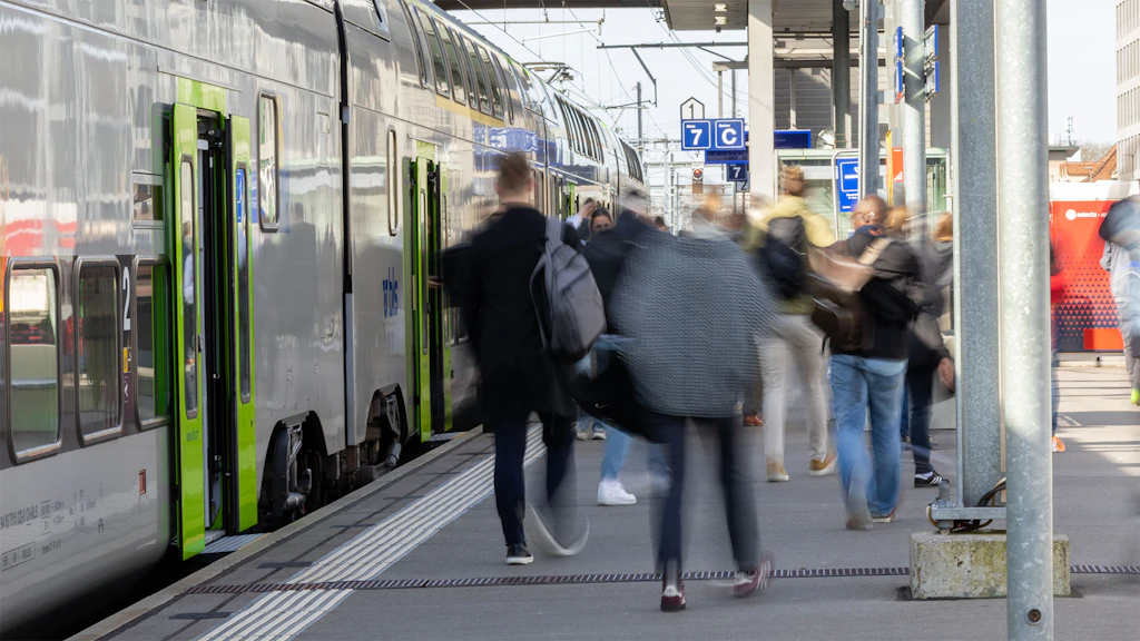 A suburban train and passengers at Wankdorf station