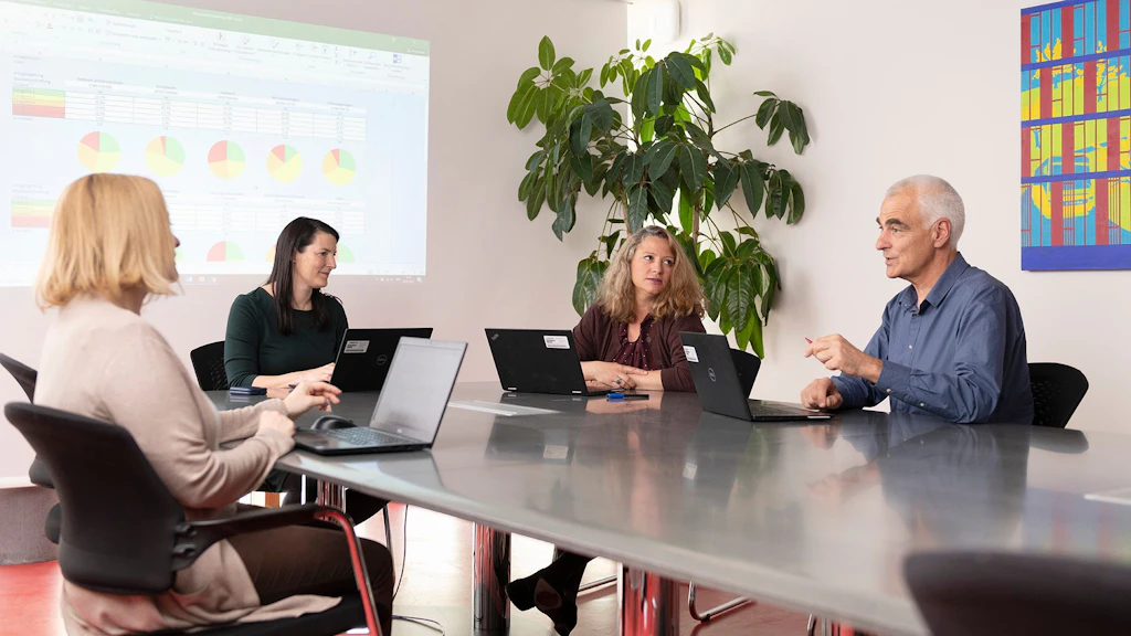 Four FOT employees in a meeting room