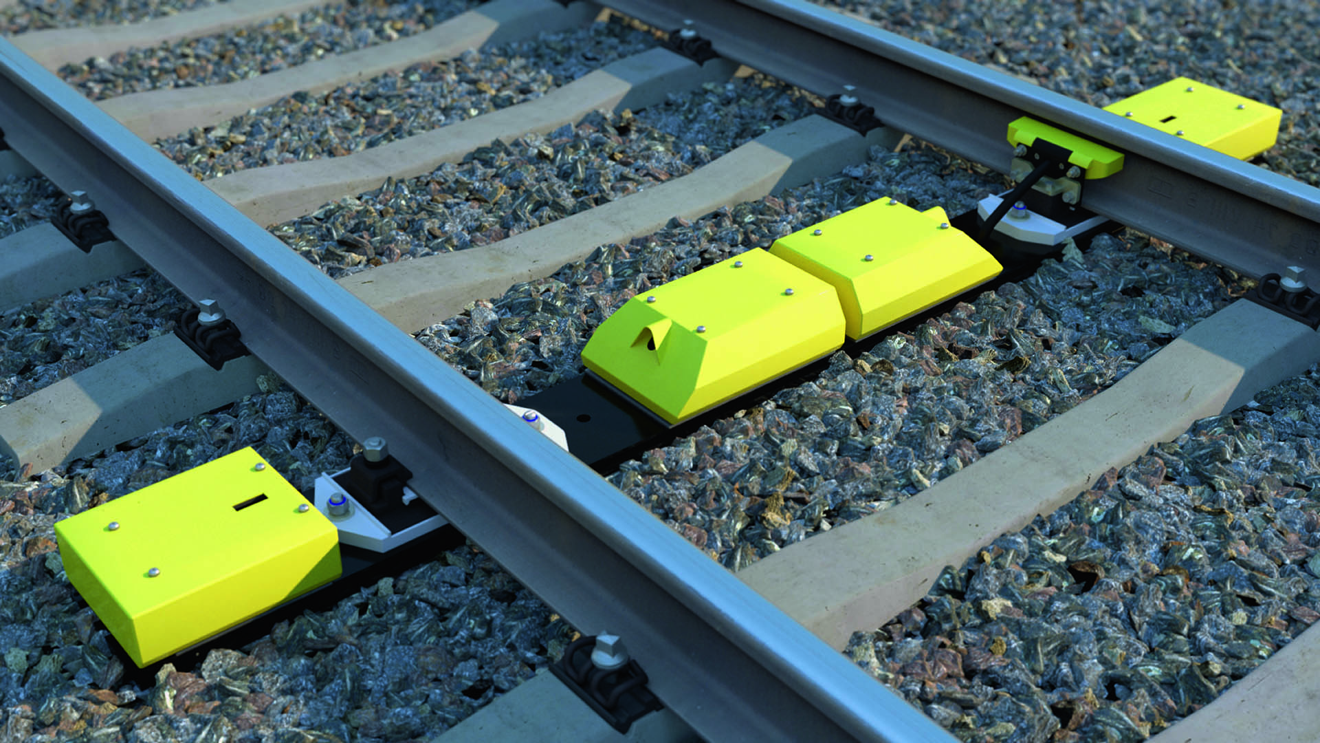 Des boîtes jaunes posées entre les rails.